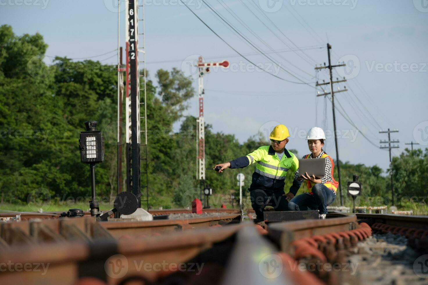 Asian railway engineer inspects a train station Engineer working on
