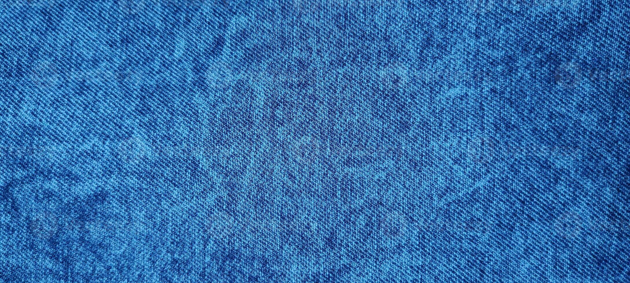 Stone wash and Blue denim fabric close up photography, denim jeans cloth, denim texture, indigo photo