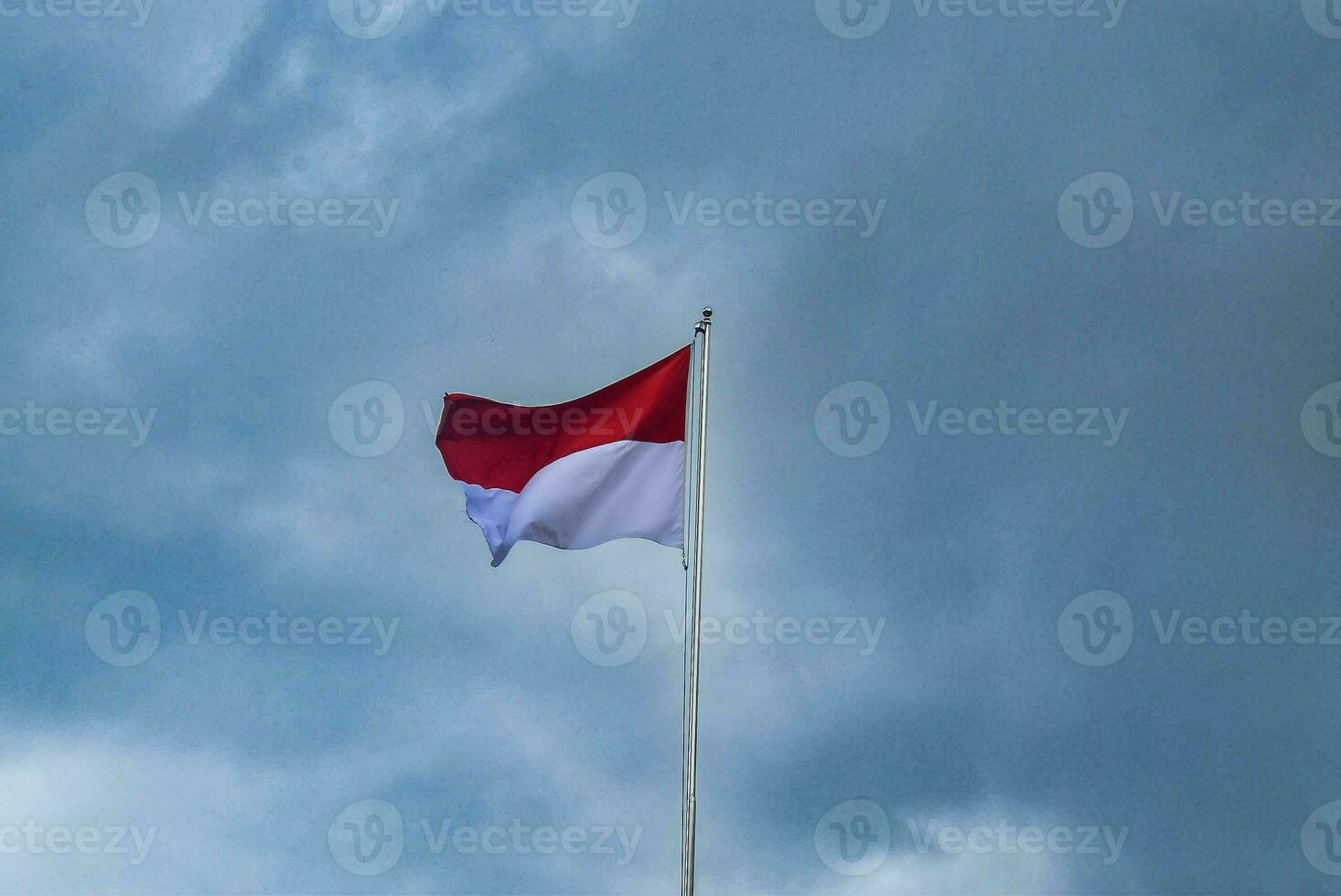 Indonesian Flag Fluttering with Clouds Background - Symbol of National Pride and Serenity photo