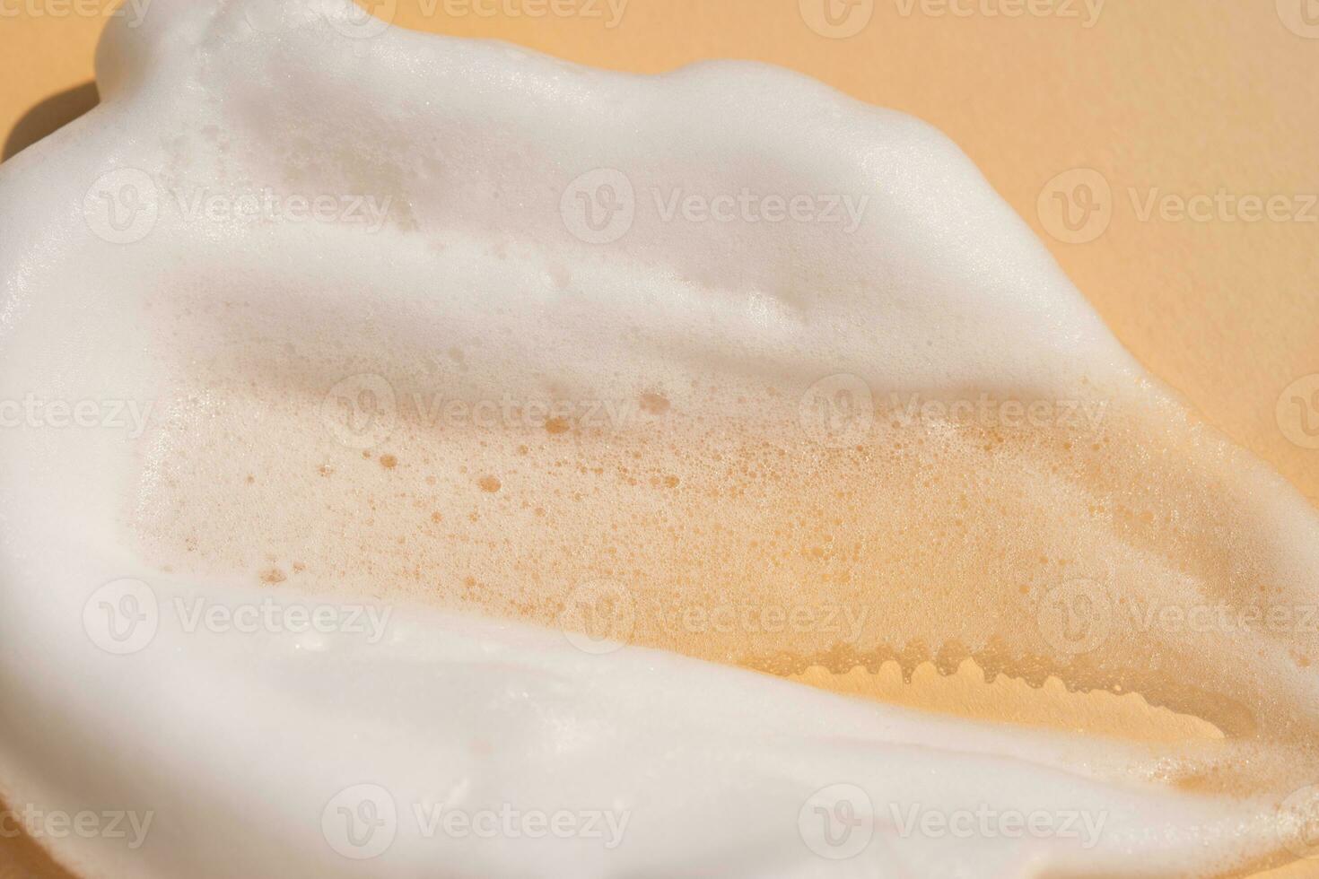 Soap foam on a light beige background. photo