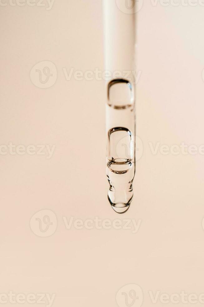 Cosmetic product in a pipette with bubbles. photo