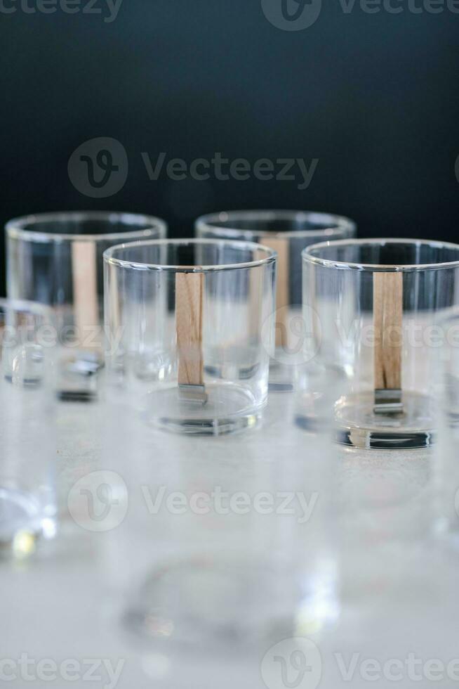 Glass glasses with wicks are on the table. photo