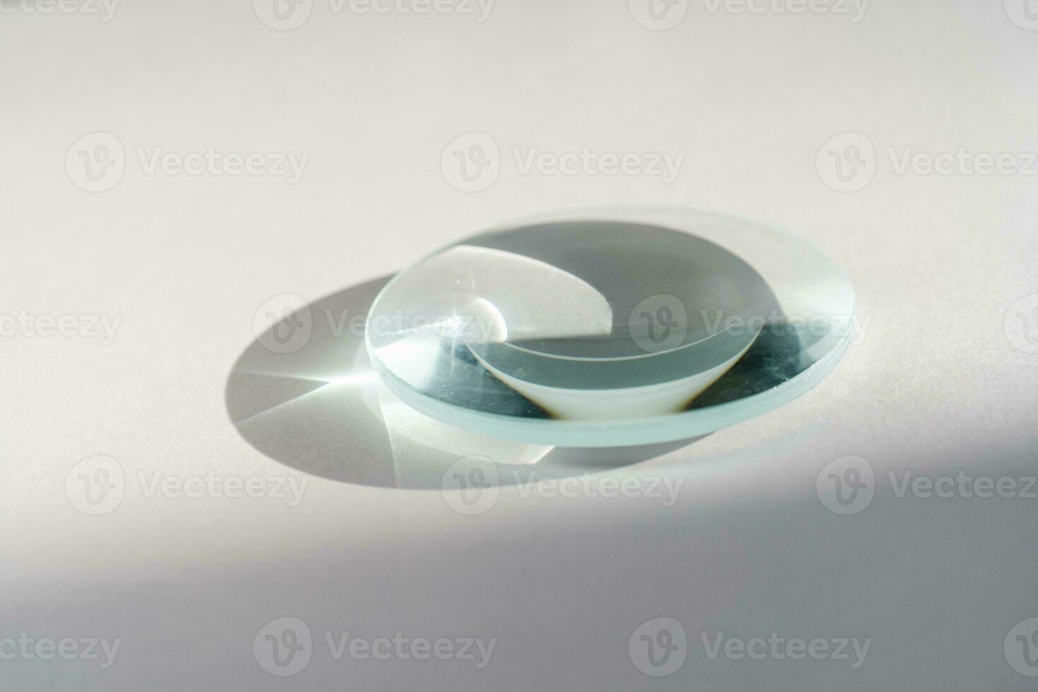 Transparent crystal lens on a white background. photo