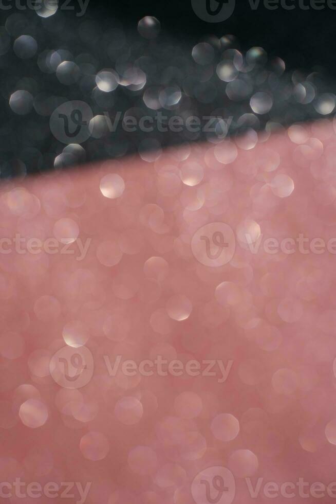 Black and pink abstract glitter background with shiny bokeh photo