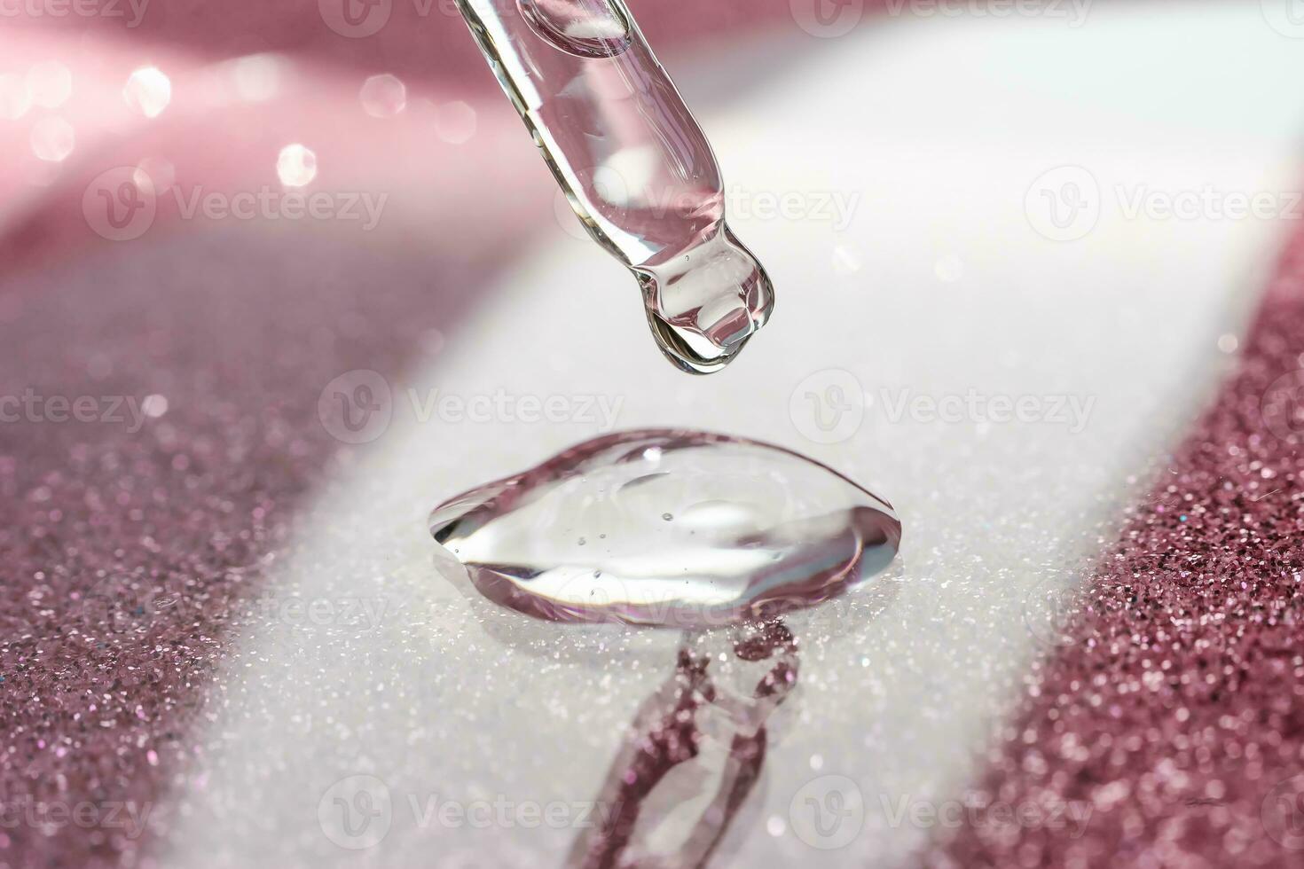 Cosmetic pipette with a pink on dark background. photo