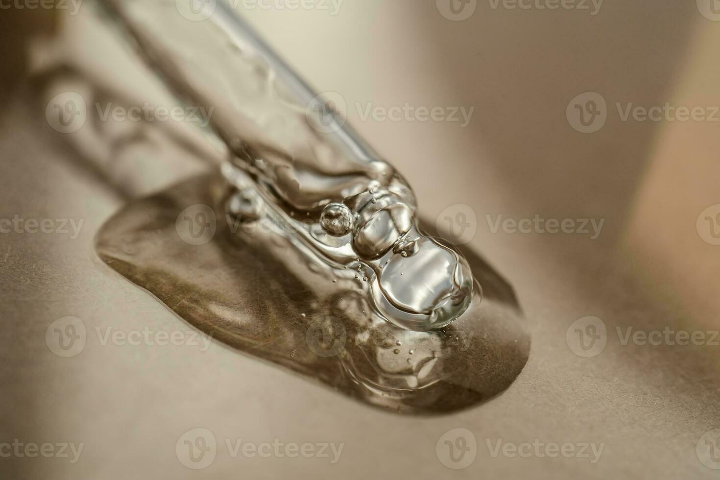 The texture of serum or oil with a pipette on a beige background. photo