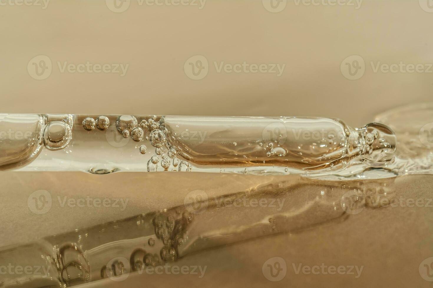 The texture of serum or oil with a pipette on a beige background. photo