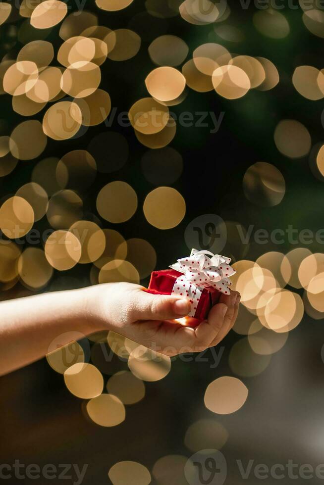 Gifts on the background of a Christmas tree with a bokeh. photo