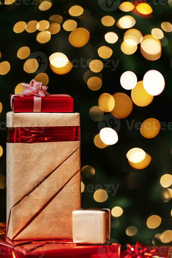Gifts on the background of a Christmas tree with a bokeh. photo