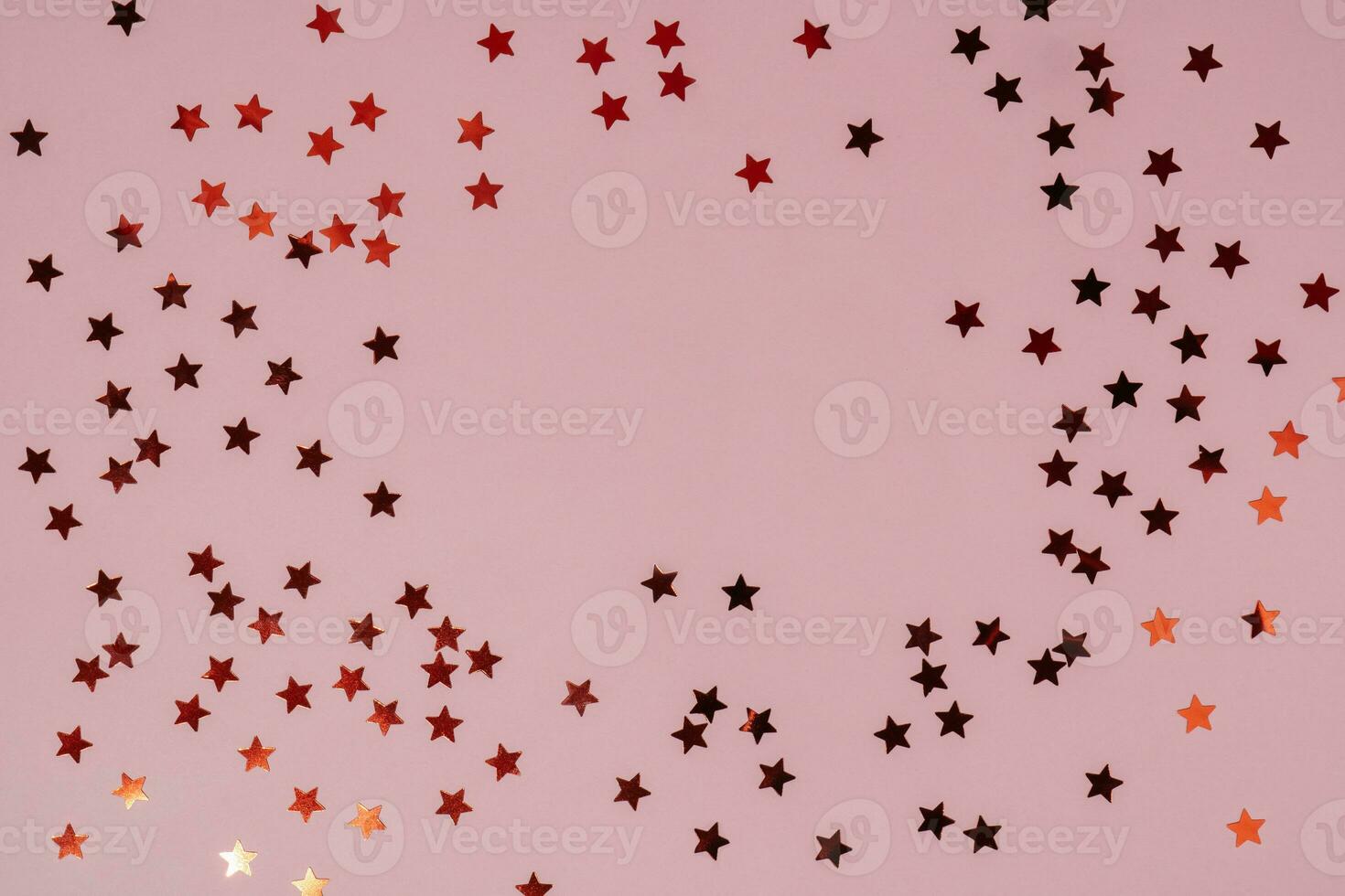 Abstract pink background with sparkles in the shape of stars. photo