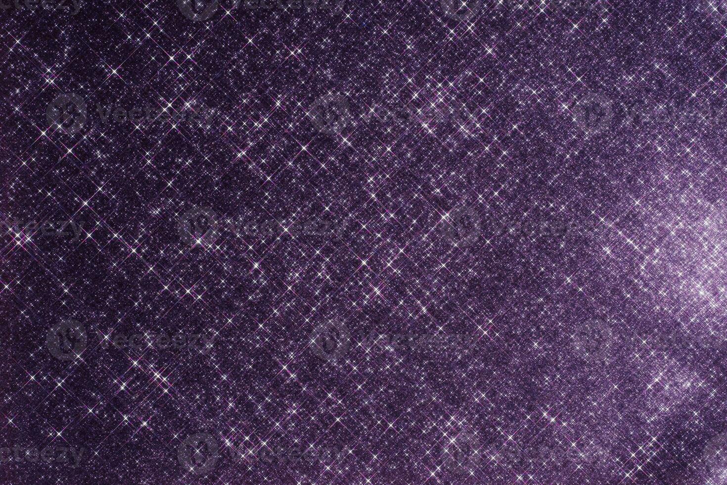 Abstract violet background with sparkles in the shape of stars. photo