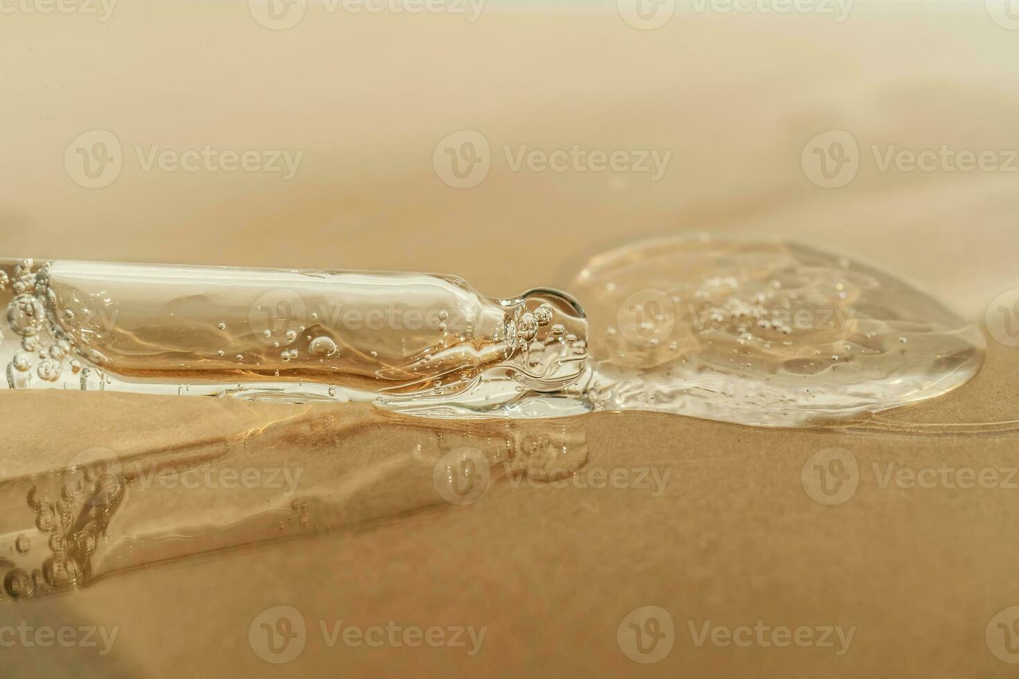 The texture of serum or oil with a pipette on a beige background. photo