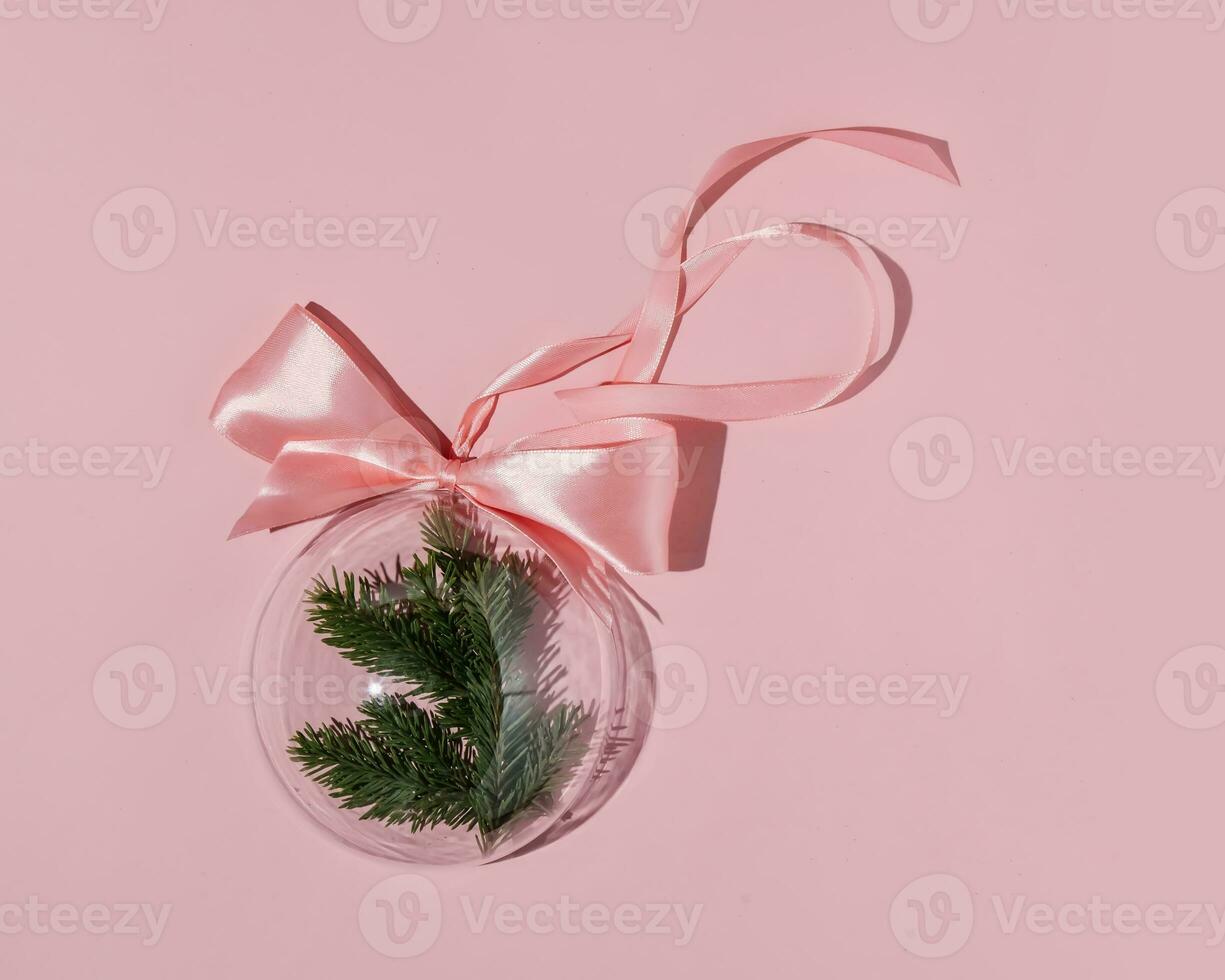 A balloon with a Christmas branch on a pink background. photo