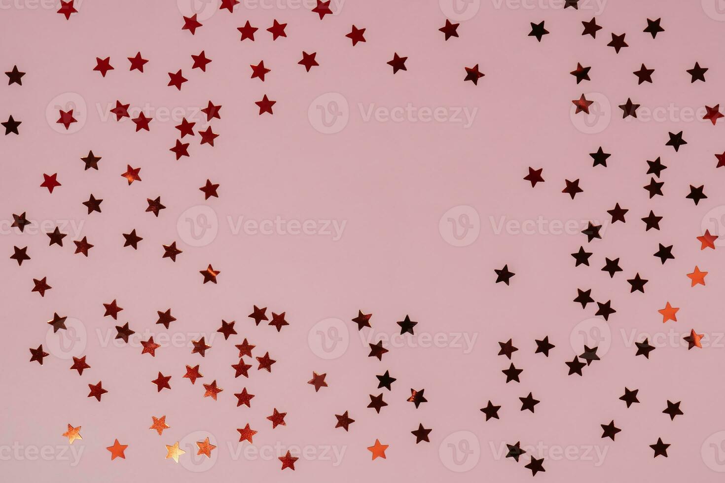 Abstract pink background with sparkles in the shape of stars. photo