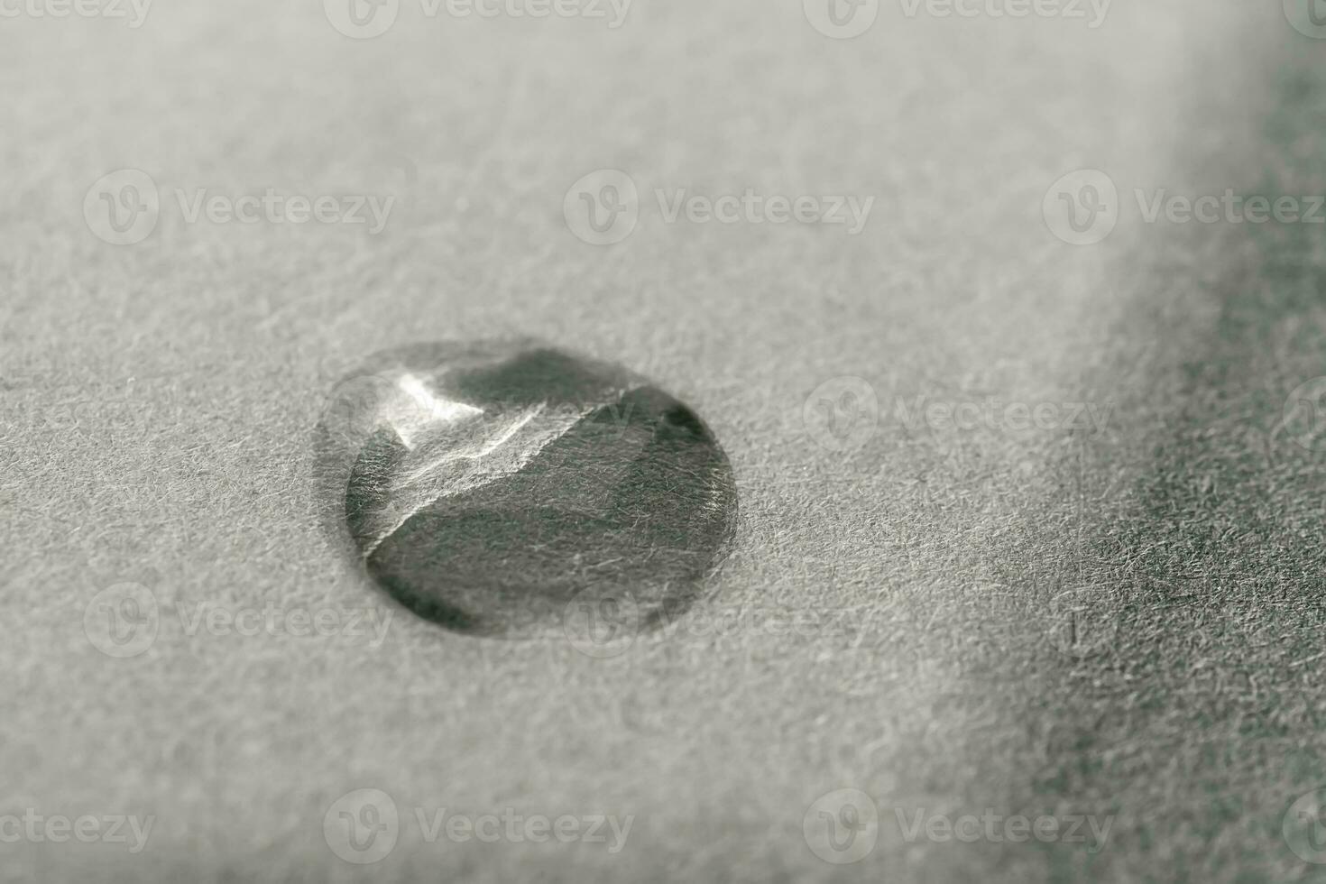 A drop of cosmetic product on a grey background. Texture. photo