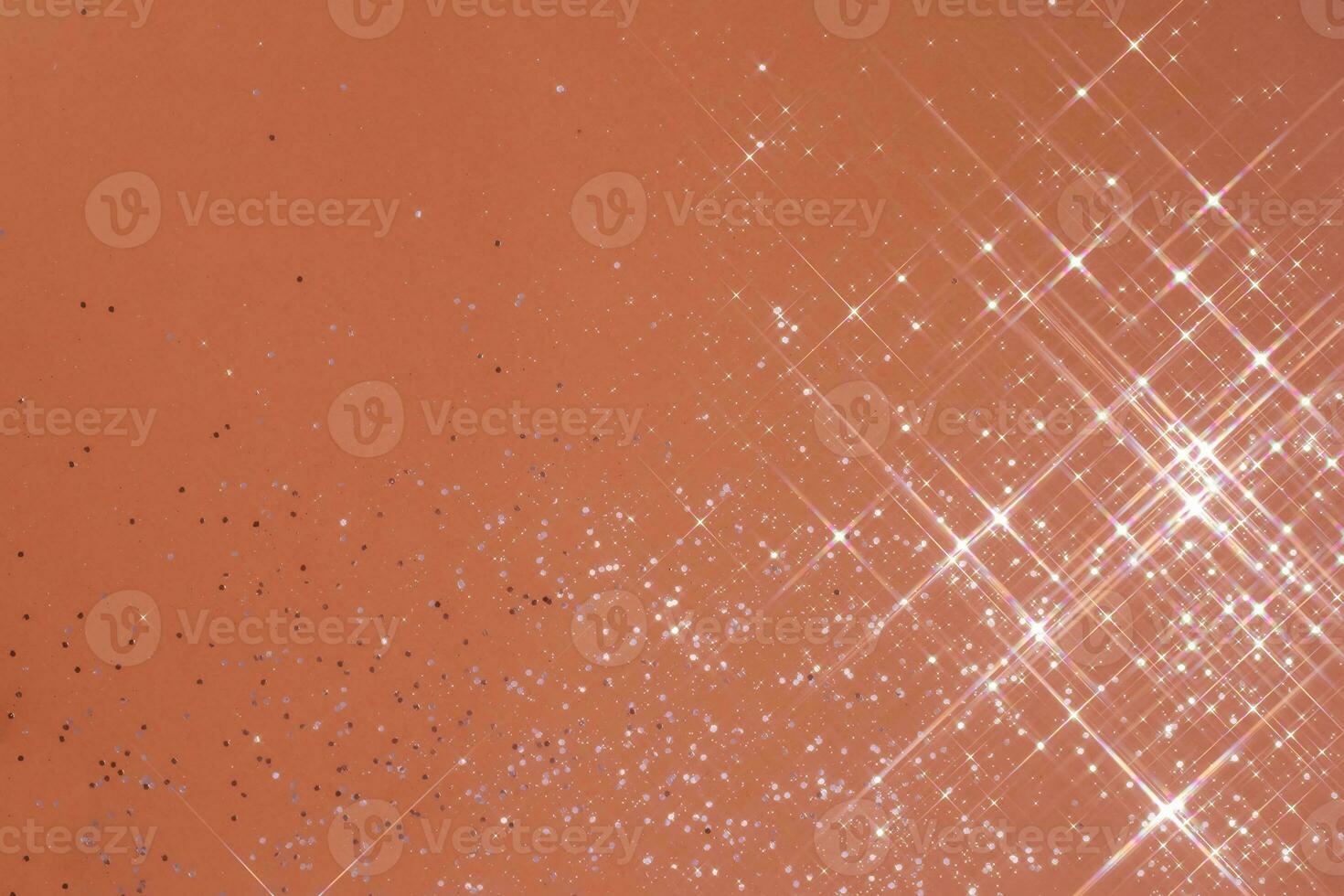 Abstract coral background with sparkles in the shape of stars. photo