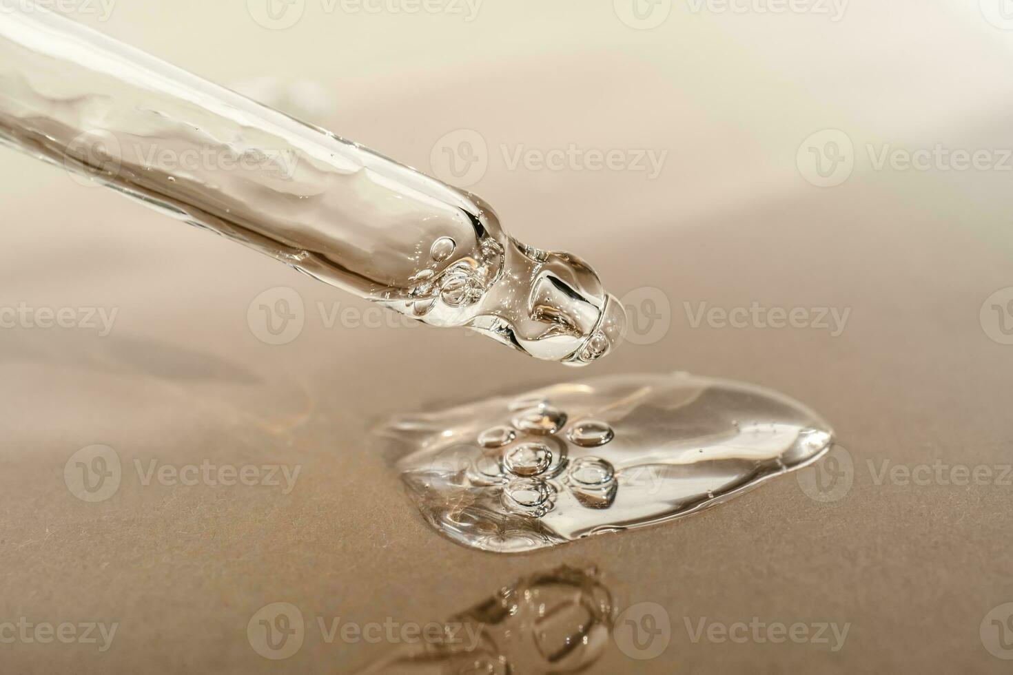 The texture of serum or oil with a pipette on a beige background. photo