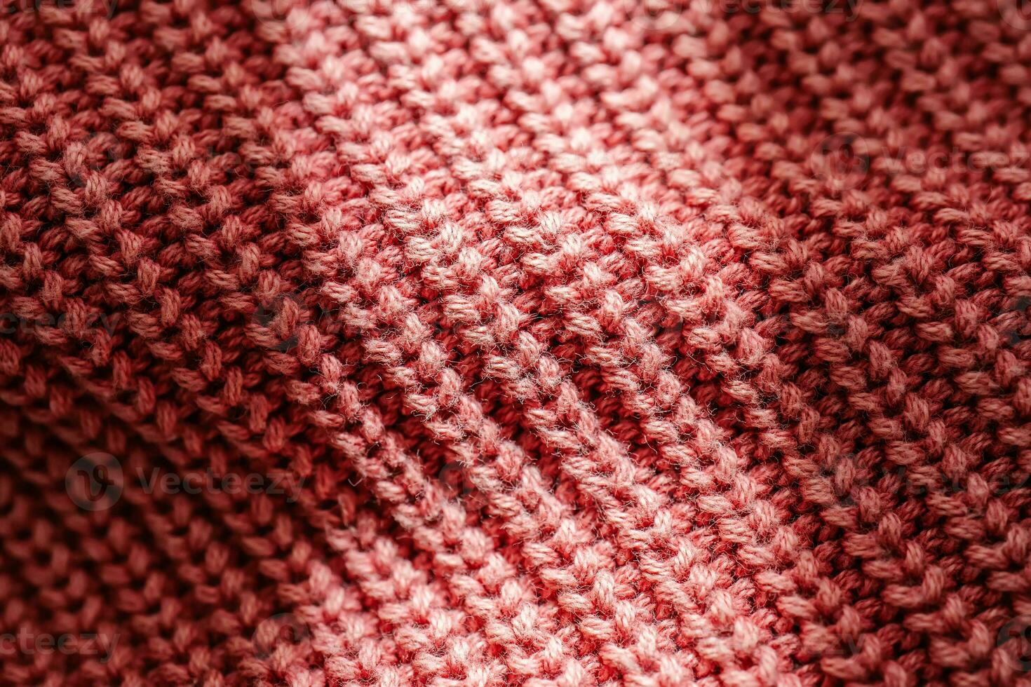Knitted texture of a pink sweater or scarf close-up. photo