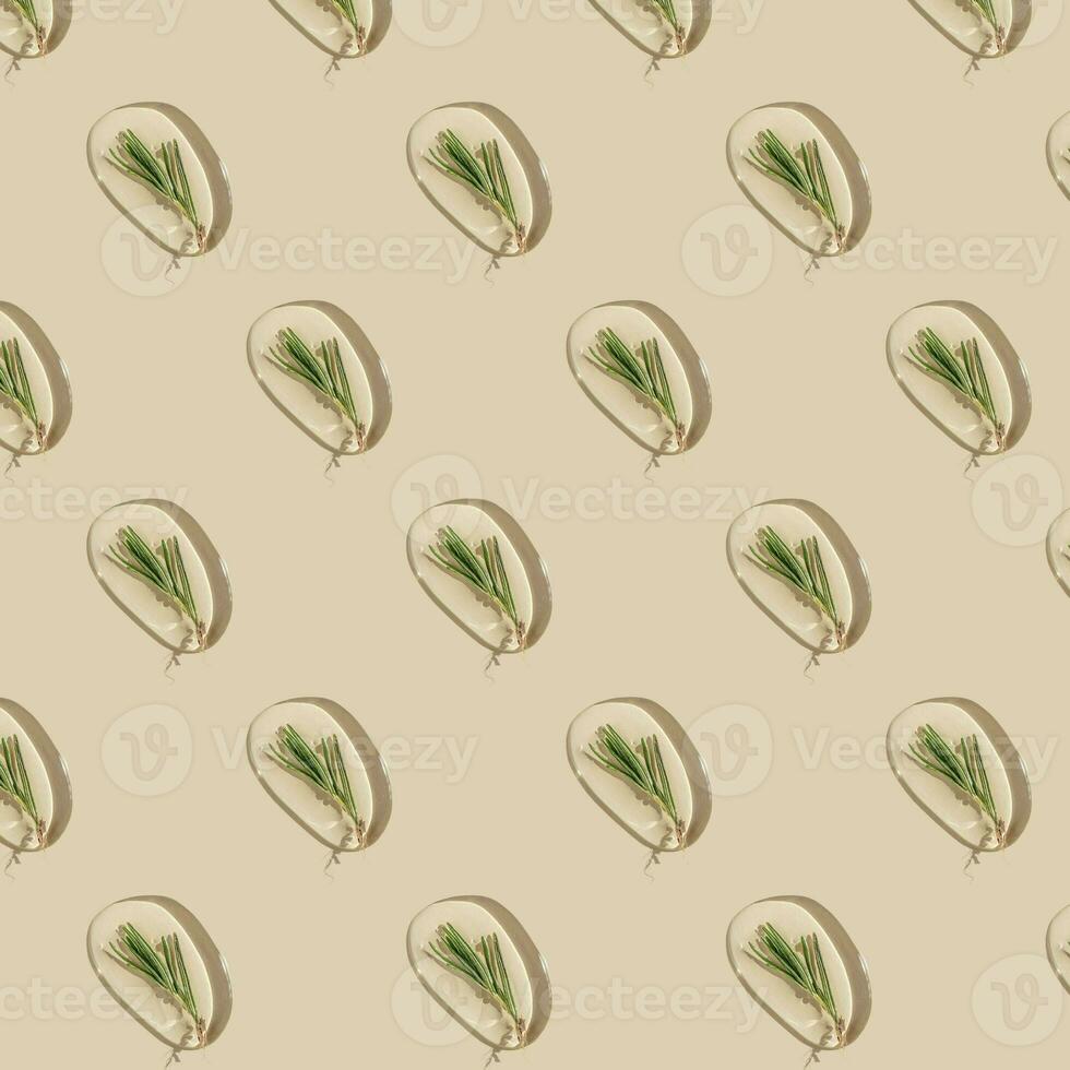 A drop of cosmetic gel with rosemary on a beige background. Pattern. photo