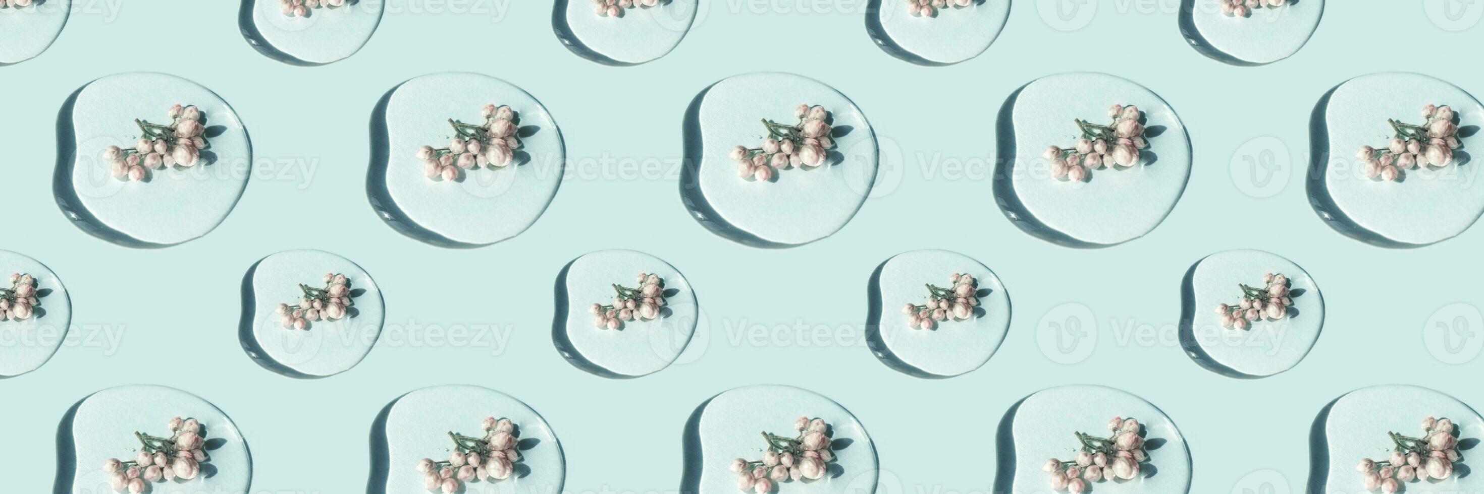 A drop of cosmetic gel or water with flowers. Pattern. photo