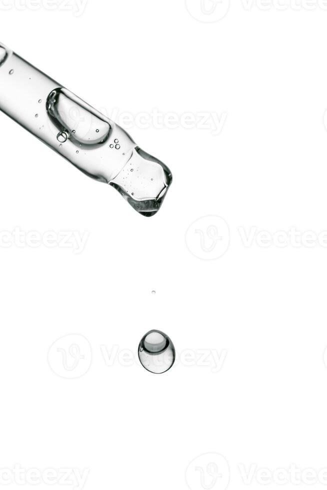 Transparent pipette with cosmetics on a white isolated background. photo