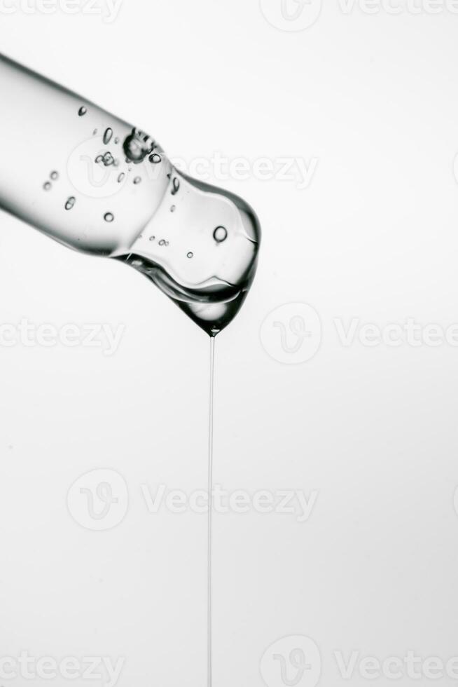 Transparent pipette with cosmetics on a white isolated background. photo