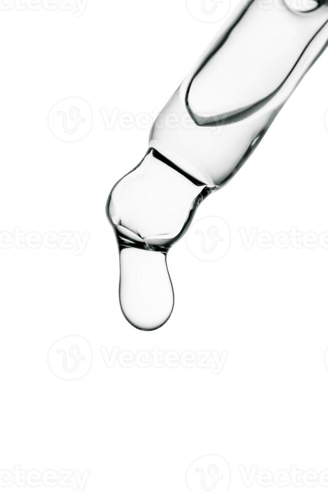 Transparent pipette with cosmetics on a white isolated background. photo