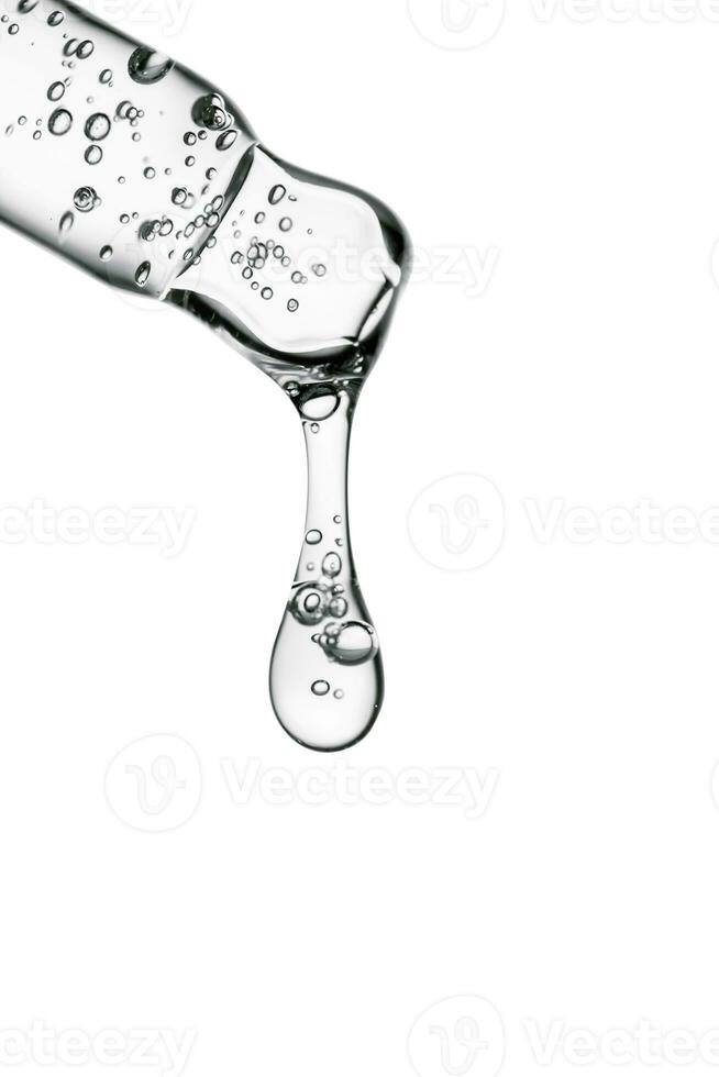 Transparent pipette with cosmetics on a white isolated background. photo