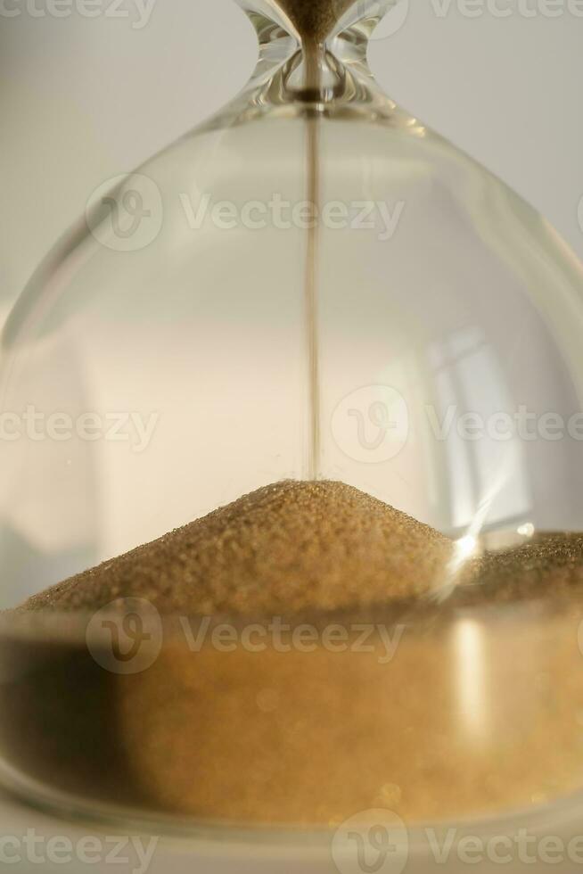 Transparent hourglass on a white sunny background. photo