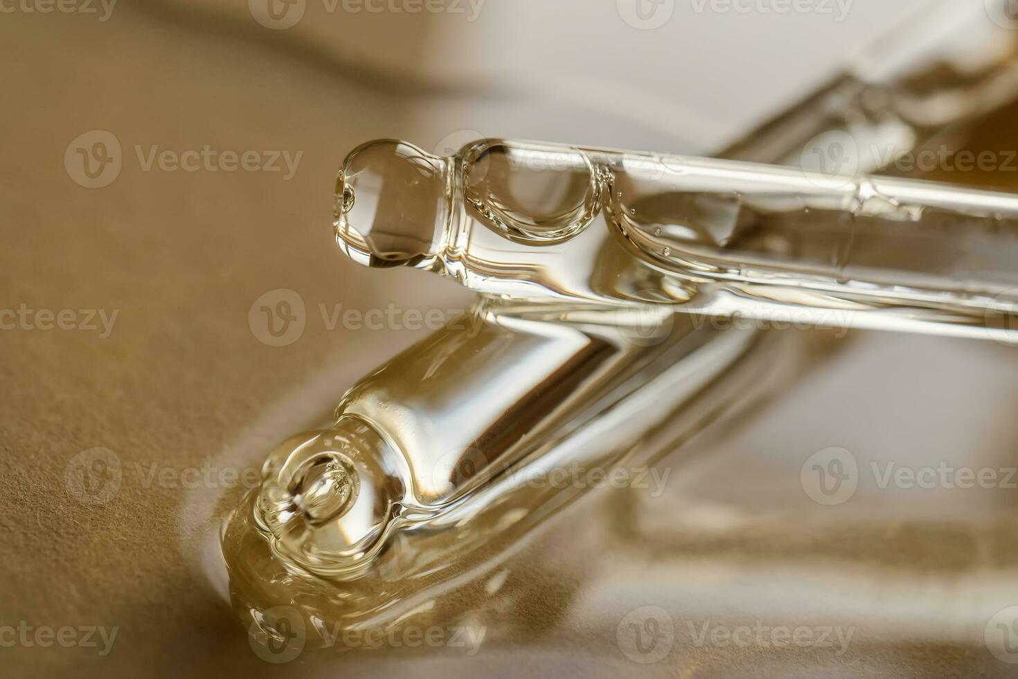 Pipettes with oil or serum on a golden background. photo