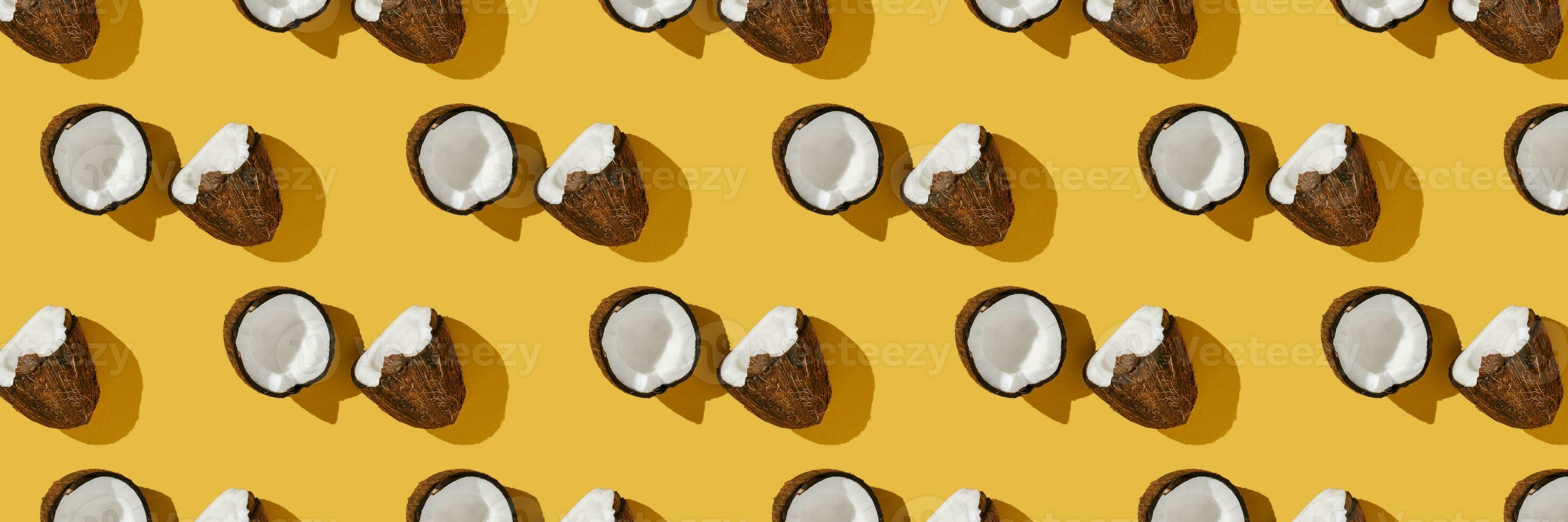 A pattern of coconuts on a bright yellow background. photo