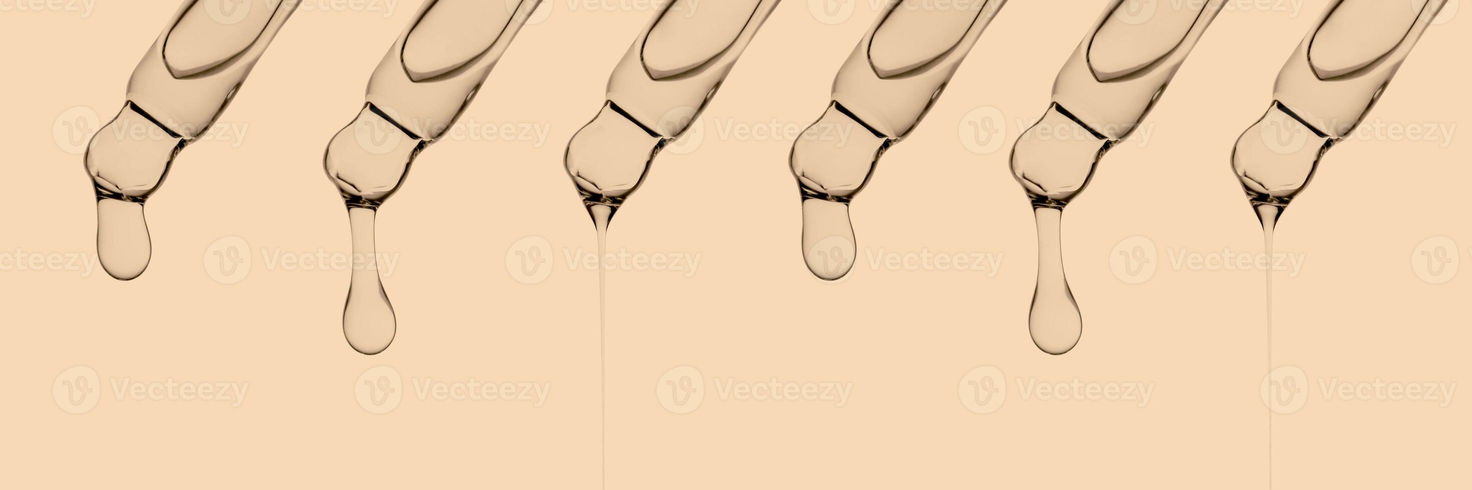 A banner with several pipettes with serum or other cosmetic product. photo