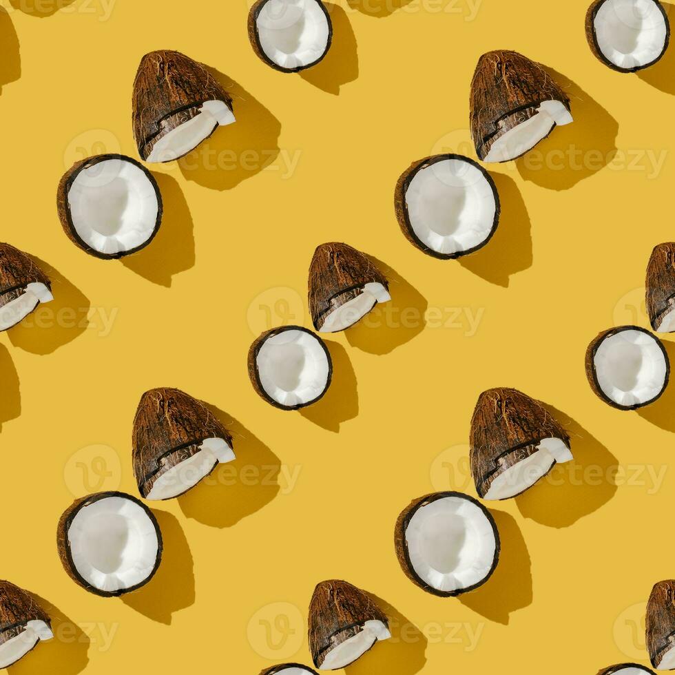 A pattern of coconuts on a bright yellow background. photo