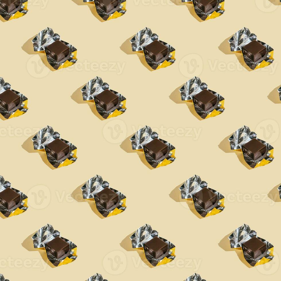 Beautiful chocolate wrapped pattern on beige background. photo