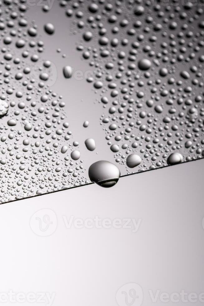 Drops of water on a transparent gray background. photo