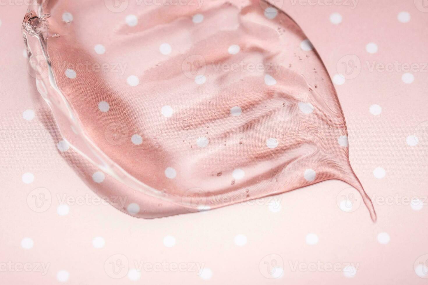 transparente hialurónico gel en un rosado polca puntos antecedentes. foto