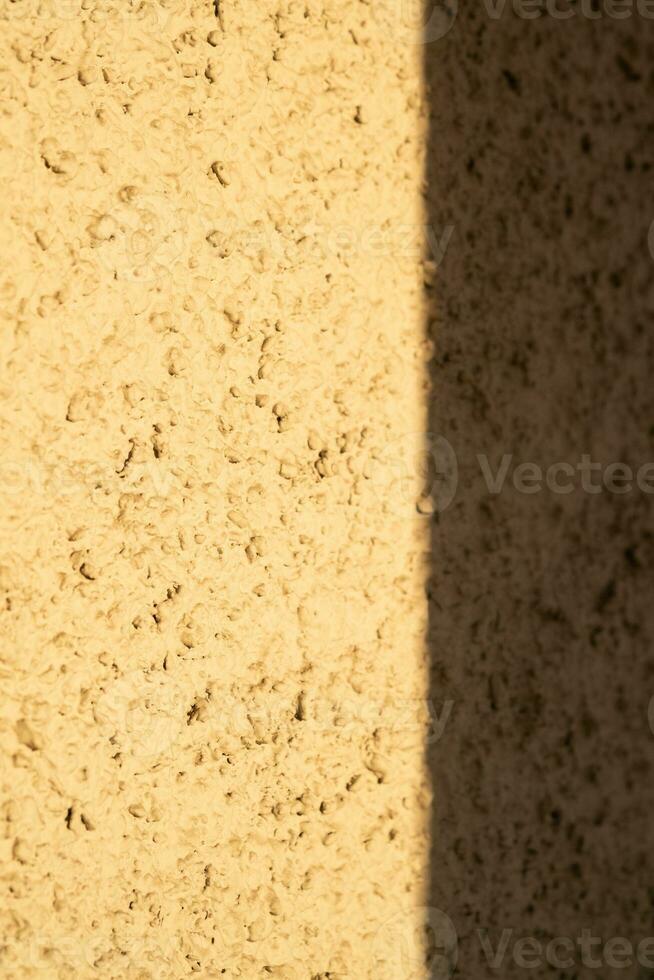 A shadow on the wall in the rays of the setting sun. photo