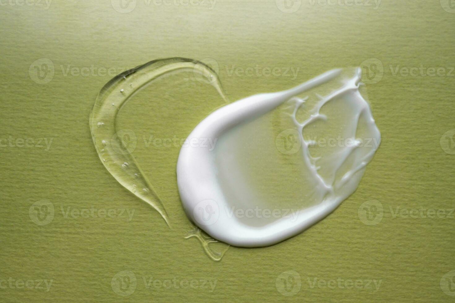 Serum and cream on a green background. Textures. photo