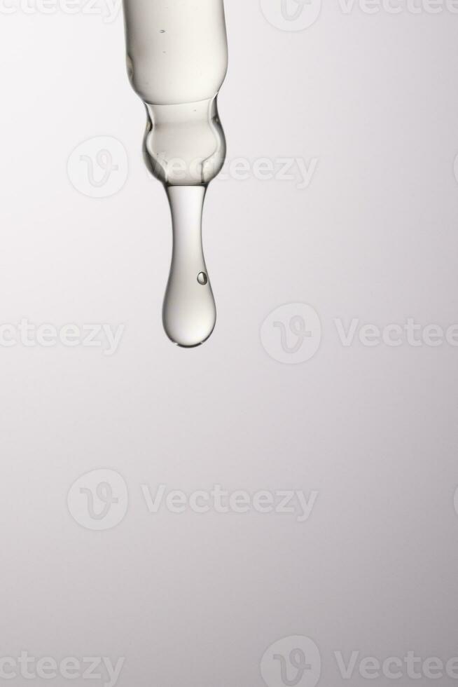 Pipette with serum, gel, oil or other cosmetic product. photo