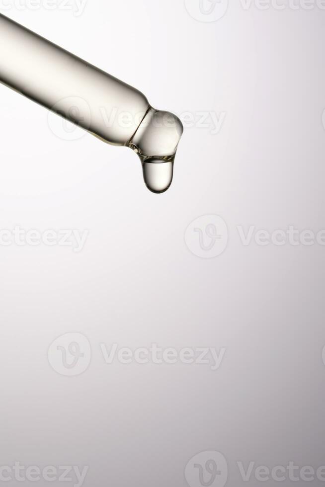 Pipette with serum, gel, oil or other cosmetic product. photo