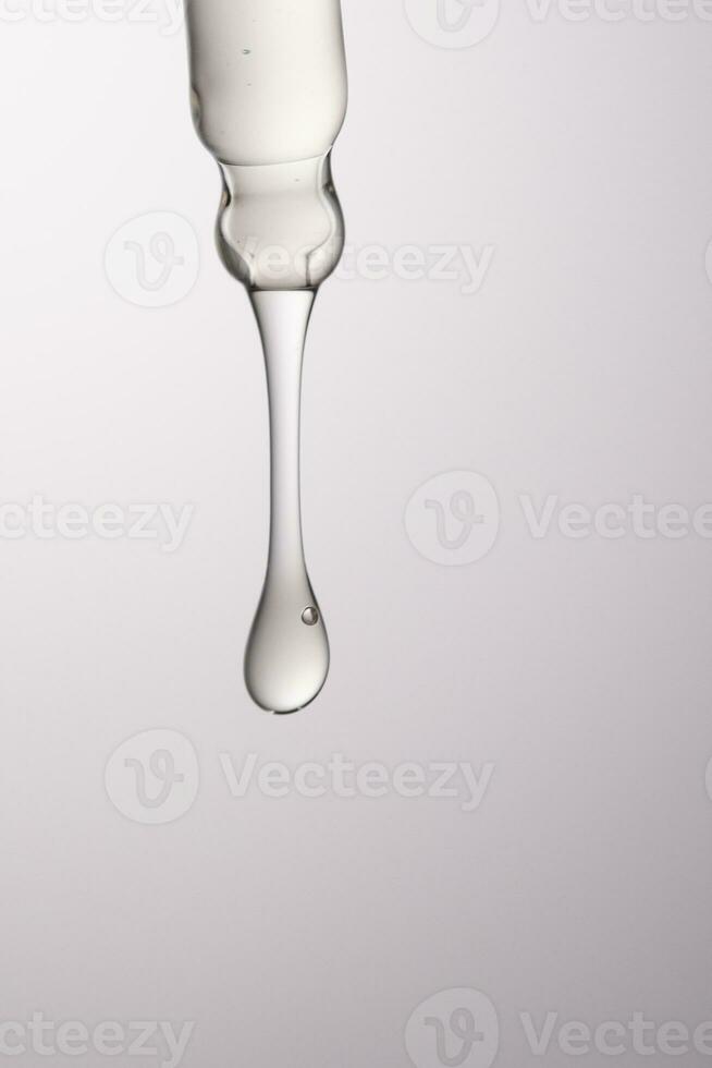 Pipette with serum, gel, oil or other cosmetic product. photo