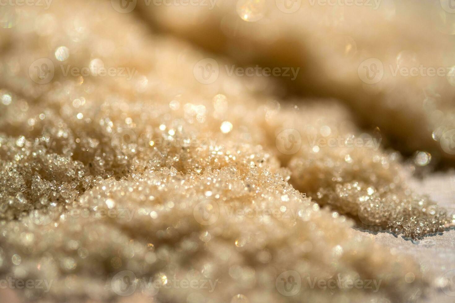 The texture of a yellow shining scrub on a beige background. photo