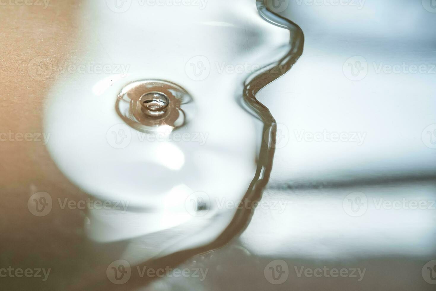 A pipette of cosmetic gel on a beige background. photo