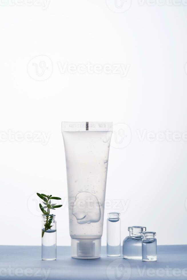 Transparent bottle of cosmetic gel on a white and blue background. photo