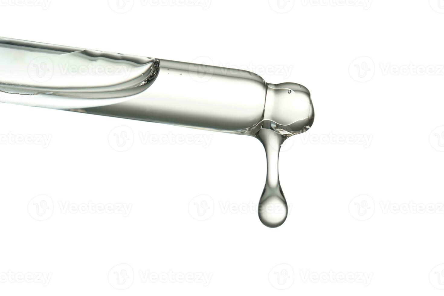 Pipette with a drop of cosmetic product on a white background. photo