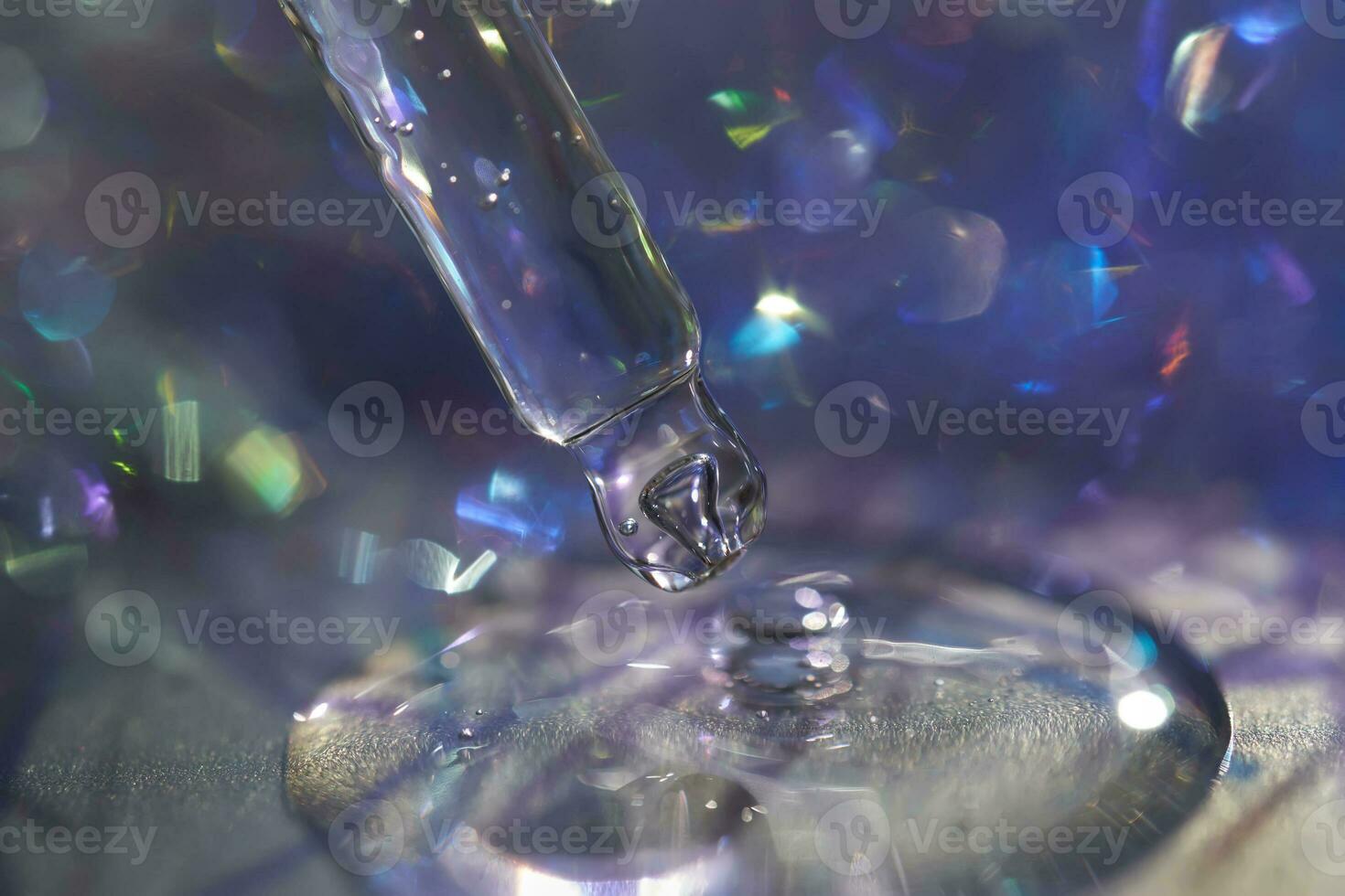 A pipette with a drop of serum in a Christmas theme . photo
