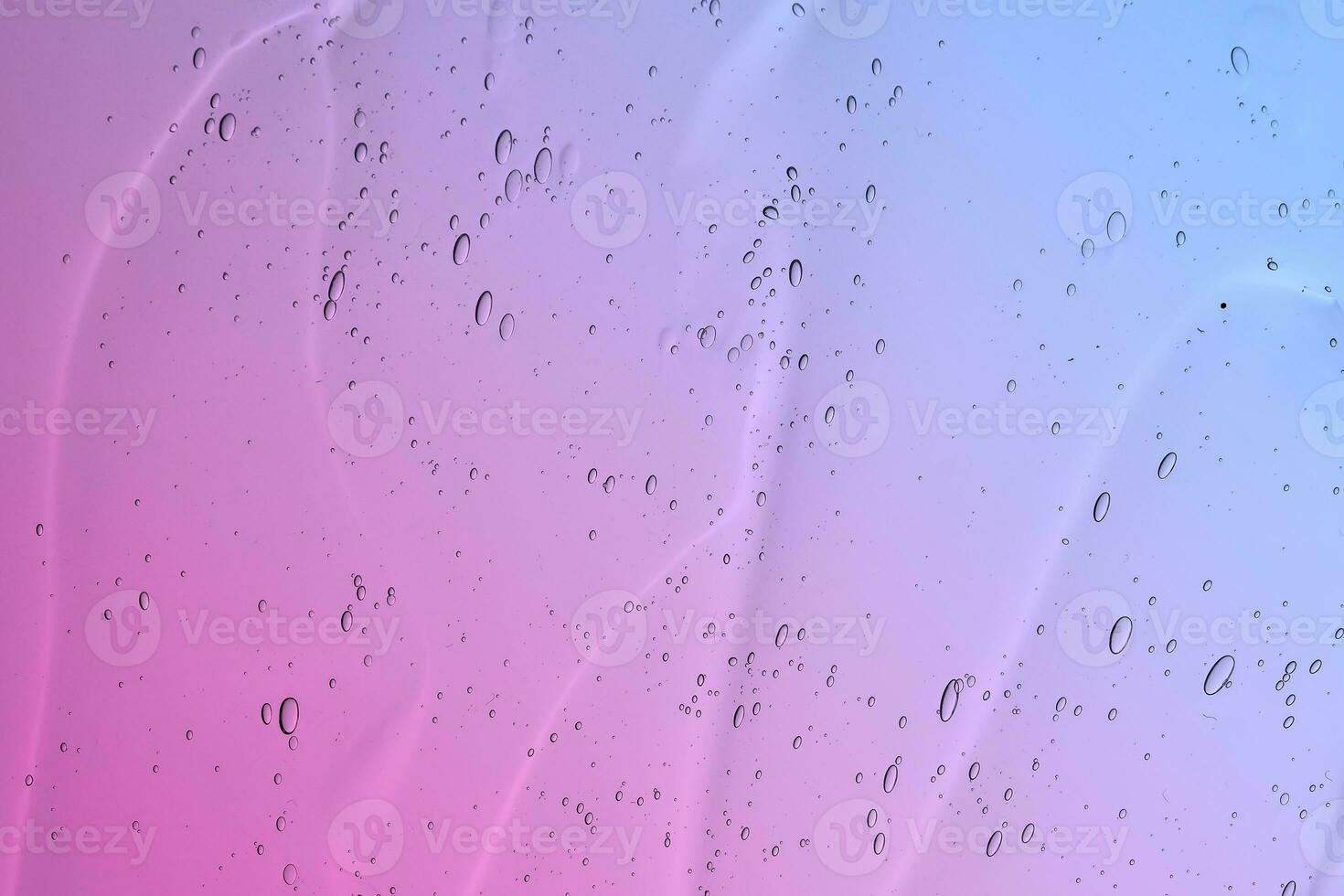 The texture of a cosmetic gel with bubbles on the background of a gradient from pink to blue. photo