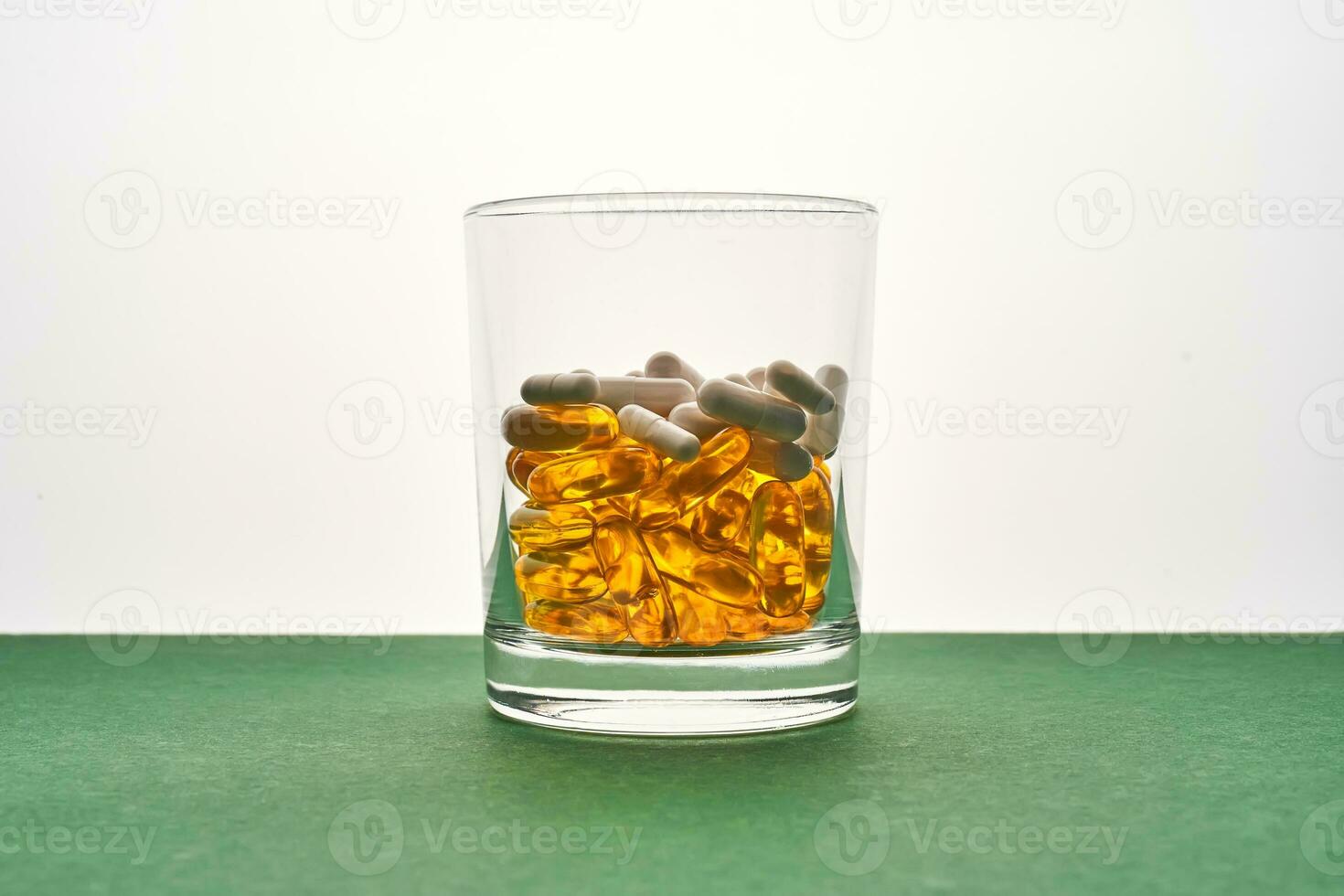 A glass with vitamins and other medical preparations. photo
