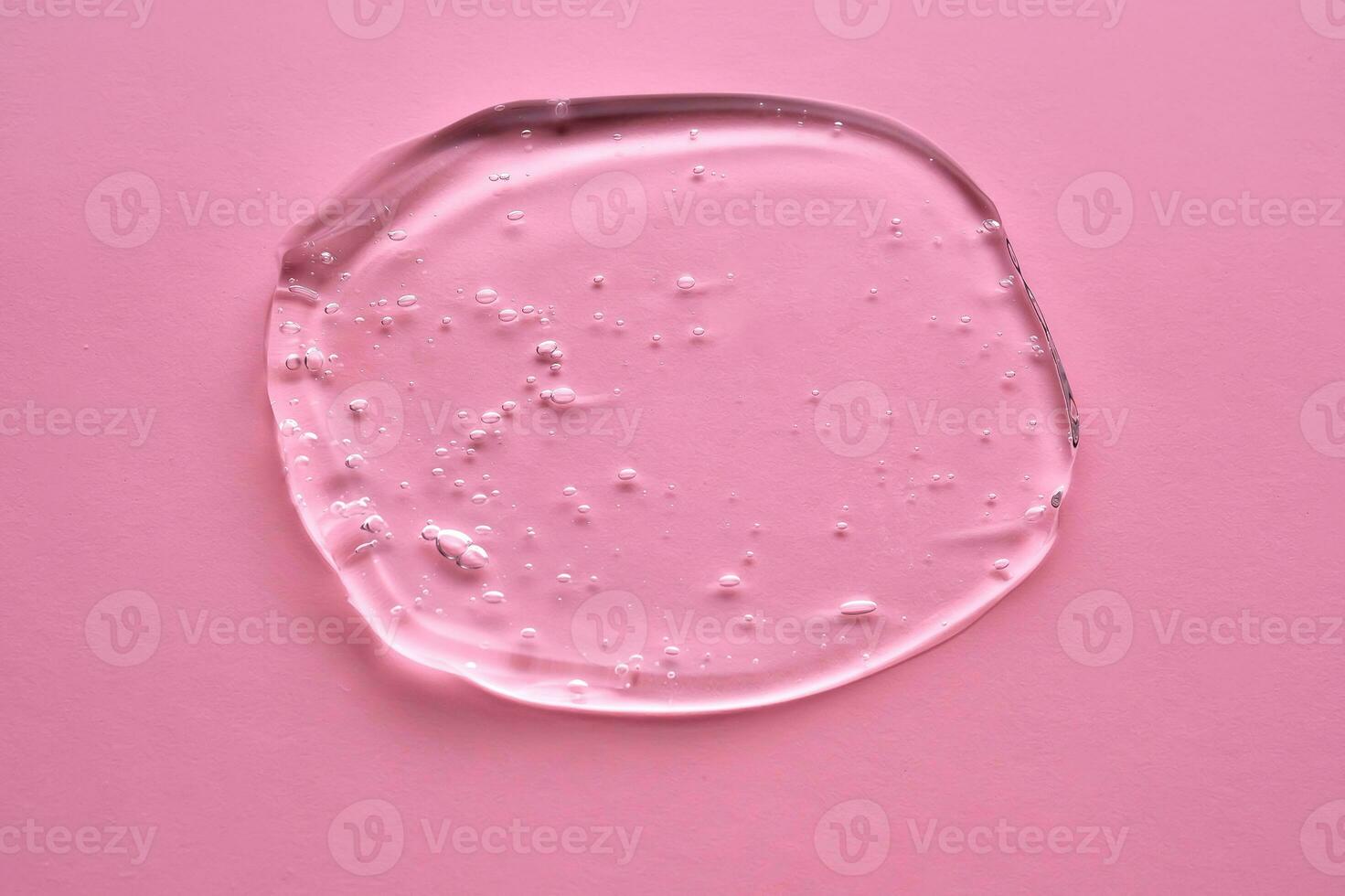 el textura de el cosmético gel en un rosado antecedentes. foto