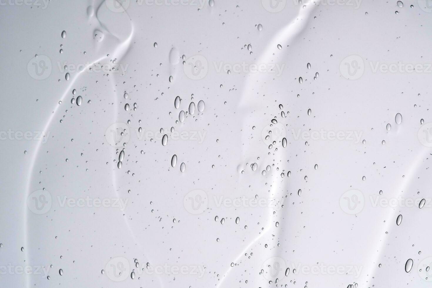 The texture of a cosmetic gel with bubbles on a white background. photo